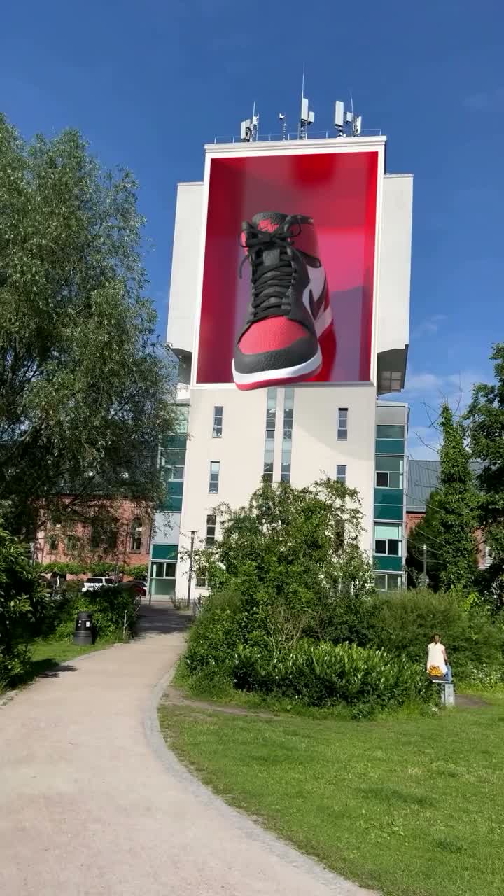 Nike sneaker on a digital building facade, fake out-of-home composite